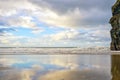 Wet sand and cliff reflections