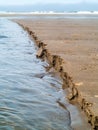 Wet Sand Eroding at the Beach Royalty Free Stock Photo