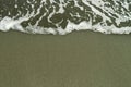 Wet sand and wave on sea beach background Royalty Free Stock Photo