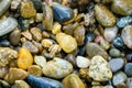 Wet sea pebbles as nature background. Beautiful sea stones of different sizes, colors and texture. Royalty Free Stock Photo