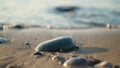 Wet sea pebbles on the sand with blurred small wave background Royalty Free Stock Photo