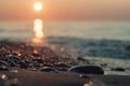 Wet sea pebbles and sand on the sunset beach Royalty Free Stock Photo
