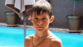 Wet serious boy after a swimming pool looks at the camera, close-up Royalty Free Stock Photo