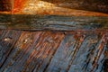 Wet, shiny, worn floor boards of an old, wooden ship wreck on the Mediterranean coast in Israel