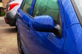 Wet side mirror of blue car closeup Royalty Free Stock Photo