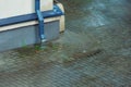 Wet sidewalk and roadway in the city after the rain. Water splashes on the road during a downpour. Large raindrops on the surface