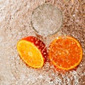 Wet slices of orange and a glass Royalty Free Stock Photo