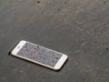Wet smart phone dropped on flooding floor Royalty Free Stock Photo