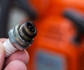 Wet spark plug in a chainsaw. Rich fuel mixture. Malfunction in the ignition system. industry