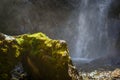 Wet from the spray of the waterfall stones with moss. Royalty Free Stock Photo