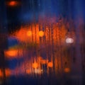 Wet steamy window inside bus on a rainy day, blurred orange and blue cars lights background - abstract moody background Royalty Free Stock Photo