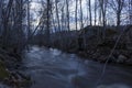 Wet stones in the foreground, spring flood of a usually small river in a forest in northern Sweden. Royalty Free Stock Photo