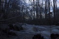 Wet stones in the foreground, spring flood of a usually small river in a forest in northern Sweden. Royalty Free Stock Photo