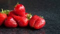 Wet strawberries. A bunch of wet ripe strawberries with water drops on a black background. Red berries. Selective focus Royalty Free Stock Photo