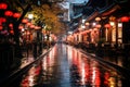 a wet street lined with red lanterns at night