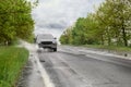 Wet suburban road with car