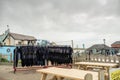 Wet suits hanging on a rack in front of a surf school