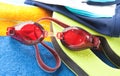 Wet swimming goggles and towel Royalty Free Stock Photo