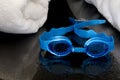 Wet swimming goggles and towels Royalty Free Stock Photo