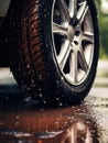 Wet tire splashing on rainy road. Concept highlights vehicle safety in rain