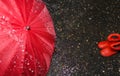 Wet umbrella and children`s rubber boots on wet asphalt Royalty Free Stock Photo