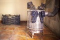 Wet used boots and socks drying over firewood stove Royalty Free Stock Photo