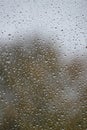 Wet with water drops glass window with light grey rainy background, closeup Royalty Free Stock Photo