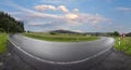 Wet winding road in rural Eifel landscape