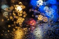 Wet the window with the background of the night city with colored lights Royalty Free Stock Photo