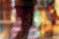 Wet window with rain drops, blurred street bokeh. Abstract blurred colorful background. Concept of weather, seasons Royalty Free Stock Photo