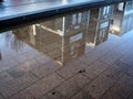 Wet winter city street reflection in a puddle Royalty Free Stock Photo