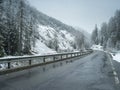 Wet winter road in Alpine Royalty Free Stock Photo