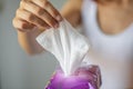 Wet wipes: woman take one wipe from package for cleaning