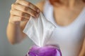 Wet wipes: woman take one wipe from package for cleaning