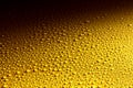 Wet yellow metal surface with glistening drops