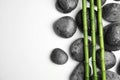 Wet zen stones and bamboo on white background, top view Royalty Free Stock Photo