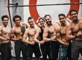 Weve all worked hard to flex like this. Portrait shot of a group of muscular people flexing in a gym.
