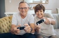 Weve become pro gamers. a mature husband and wife playing video games together. Royalty Free Stock Photo