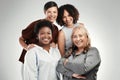 Weve been friends for years. a diverse group of women standing close together in the studio and posing.