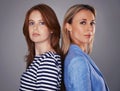 Weve got each others back. Cropped portrait of two attractive women standing back-to-back in the studio. Royalty Free Stock Photo