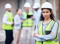 Weve got a great team. a young female architect standing with her arms crossed at a building site. Royalty Free Stock Photo