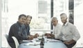 Weve got ideas in the making. Cropped portrait of a group of businessmen having a meeting around a table in an office. Royalty Free Stock Photo