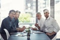 Weve got ideas in the making. Portrait of a group of businessmen having a meeting around a table in an office. Royalty Free Stock Photo