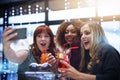 Weve got to get a pic together. a group of friends taking a selfie while having drinks at a party. Royalty Free Stock Photo