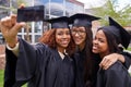 Weve made friends for life. three female graduates taking a selfie on a phone. Royalty Free Stock Photo