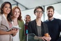 Weve made it to the top together. Portrait of a group of young creatives standing together in a modern office. Royalty Free Stock Photo