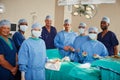 Weve saved many lives in our operating room. Portrait of a team of surgeons in an operating room.