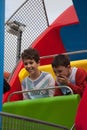 2 boys enjoying a fair ride in the UK