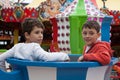 2 boys enjoying a fair ride in the UK