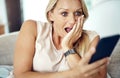 Whaaat. an attractive mature woman looking surprised while reading a text message at home. Royalty Free Stock Photo